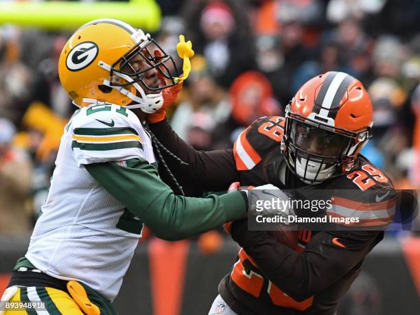 Running back Duke Johnson Jr. #29 of the Cleveland Browns stiff-arms safety Ha Ha Clinton-Dix of the Green Bay Packers, as he carries the ball...