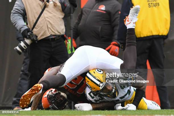 Wide receiver Josh Gordon of the Cleveland Browns falls on safety Josh Jones of the Green Bay Packers, after attempting to catch a pass in the second...