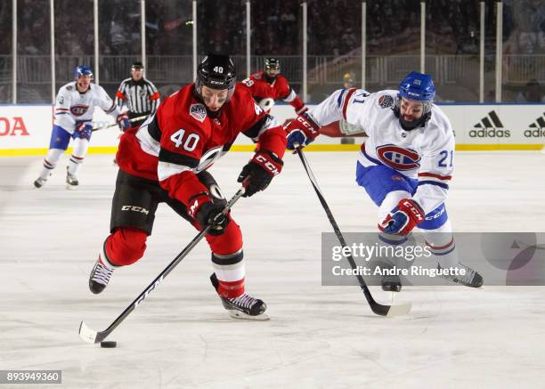 Gabriel Dumont of the Ottawa Senators skates with the puck against David Schlemko of the Montreal Canadiens during the first period of the 2017...