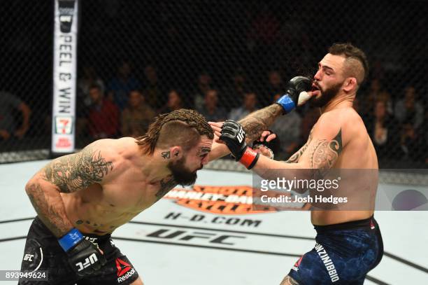 Mike Perry punches Santiago Ponzinibbio of Argentina in their welterweight bout during the UFC Fight Night event at Bell MTS Place on December 16,...