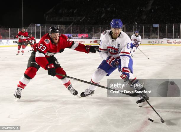 Max Pacioretty of the Montreal Canadiens pulls the puck away from Fredrik Claesson of the Ottawa Senators during the 2017 Scotiabank NHL100 Classic...
