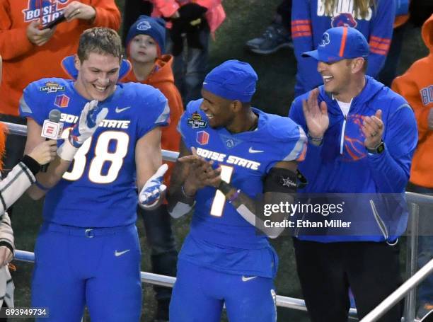 Linebacker Leighton Vander Esch, and wide receiver Cedrick Wilson of the Boise State Broncos celebrate with head coach Bryan Harsin after the team...