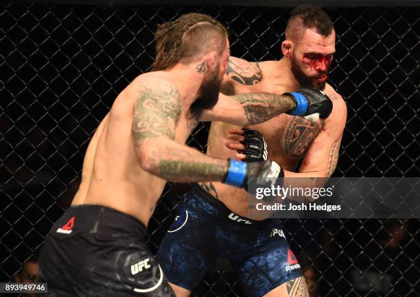 Mike Perry punches Santiago Ponzinibbio of Argentina in their welterweight bout during the UFC Fight Night event at Bell MTS Place on December 16,...