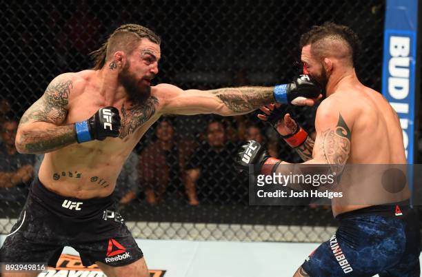 Mike Perry punches Santiago Ponzinibbio of Argentina in their welterweight bout during the UFC Fight Night event at Bell MTS Place on December 16,...