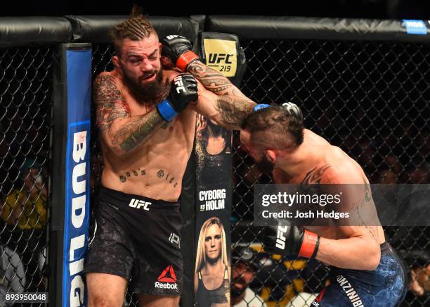 Santiago Ponzinibbio of Argentina punches Mike Perry in their welterweight bout during the UFC Fight Night event at Bell MTS Place on December 16,...