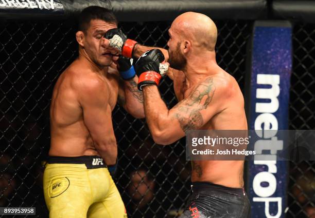 Robbie Lawler punches Rafael Dos Anjos of Brazil in their welterweight bout during the UFC Fight Night event at Bell MTS Place on December 16, 2017...