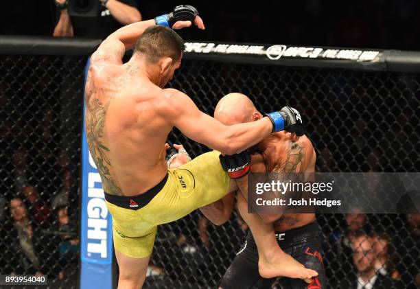 Rafael Dos Anjos of Brazil knees Robbie Lawler in their welterweight bout during the UFC Fight Night event at Bell MTS Place on December 16, 2017 in...