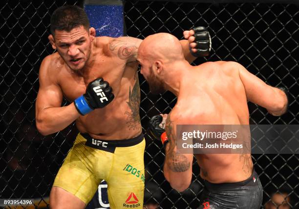 Rafael Dos Anjos of Brazil punches Robbie Lawler in their welterweight bout during the UFC Fight Night event at Bell MTS Place on December 16, 2017...