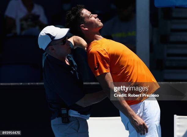 Alex Bolt of Australia receives medical attention in his match against Alex De Minaur of Australia during the Australian Open December Showdown at...