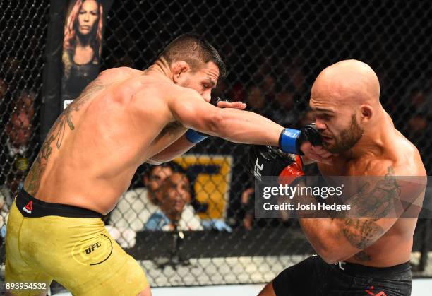 Rafael Dos Anjos of Brazil punches Robbie Lawler in their welterweight bout during the UFC Fight Night event at Bell MTS Place on December 16, 2017...