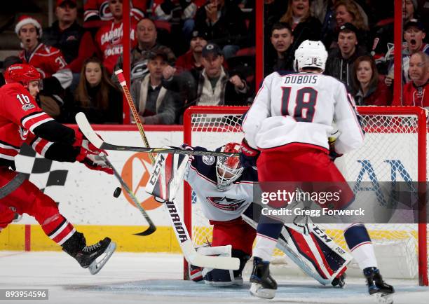 Marcus Kruger of the Carolina Hurricanes attempts to chip the puck past the blocker of Sergei Bobrovsky of the Columbus Blue Jackets during an NHL...