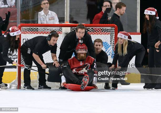 Arizona Diamondbacks pitcher Archie Bradley prepares to be slingshoted across the ice as he takes part in the Human Bowling event during the first...