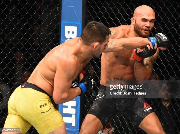 Rafael Dos Anjos of Brazil punches Robbie Lawler in their welterweight bout during the UFC Fight Night event at Bell MTS Place on December 16, 2017...