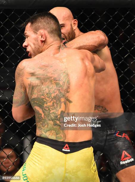 Robbie Lawler punches Rafael Dos Anjos of Brazil in their welterweight bout during the UFC Fight Night event at Bell MTS Place on December 16, 2017...