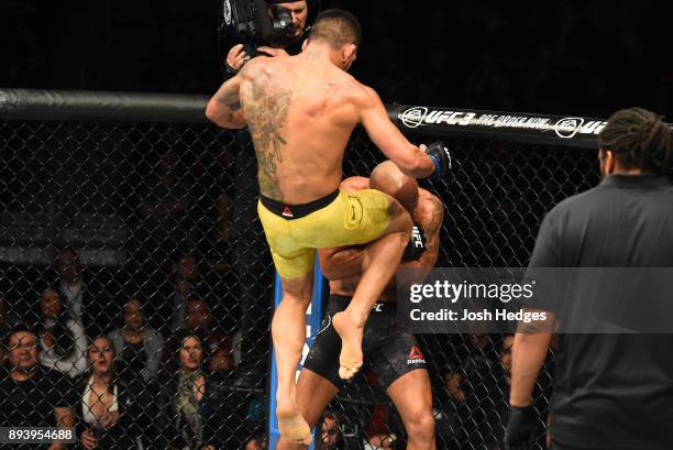 Rafael Dos Anjos of Brazil knees Robbie Lawler in their welterweight bout during the UFC Fight Night event at Bell MTS Place on December 16, 2017 in...