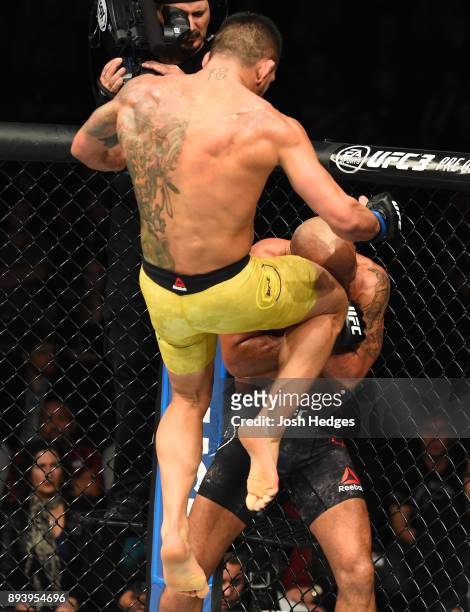 Rafael Dos Anjos of Brazil knees Robbie Lawler in their welterweight bout during the UFC Fight Night event at Bell MTS Place on December 16, 2017 in...