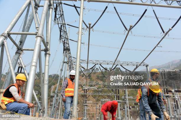 This photograph taken on November 1 shows Chinese and Pakistani engineers working on a power distribution point of the Neelum-Jhelum Hydropower...