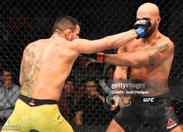 Rafael Dos Anjos of Brazil punches Robbie Lawler in their welterweight bout during the UFC Fight Night event at Bell MTS Place on December 16, 2017...