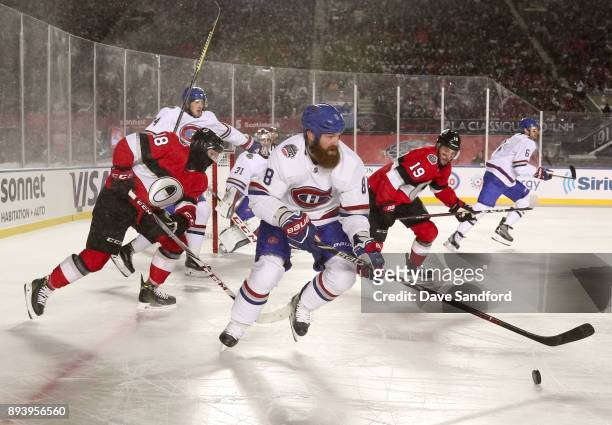 Jordie Benn of the Montreal Canadiens stickhandles the puck with Ryan Dzingel and Derick Brassard of the Ottawa Senators chasing during the 2017...