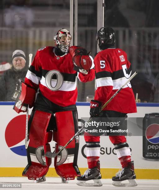 Craig Anderson and Cody Ceci of the Ottawa Senators celebrate after a 3-0 win over the Montreal Canadiens during the 2017 Scotiabank NHL100 Classic...