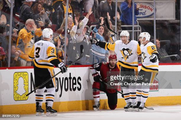 Olli Maatta, Patric Hornqvist and Chad Ruhwedel of the Pittsburgh Penguins celebrate after Maatta scored the game winning goal against the Arizona...