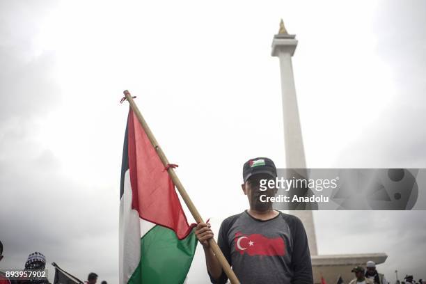 Protester wears Turkish t-shirt and hold Palestinian flags in the demonstration to support Palestine at National Monument in Jakarta, Indonesia on...