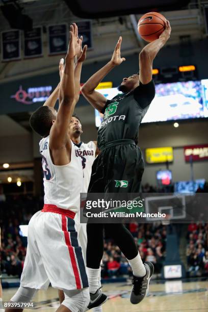 Cortez Seales of the North Dakota Fighting Hawks goes to the basket against defenders Zach Norvell Jr. #23 and Johnathan Williams of the Gonzaga...
