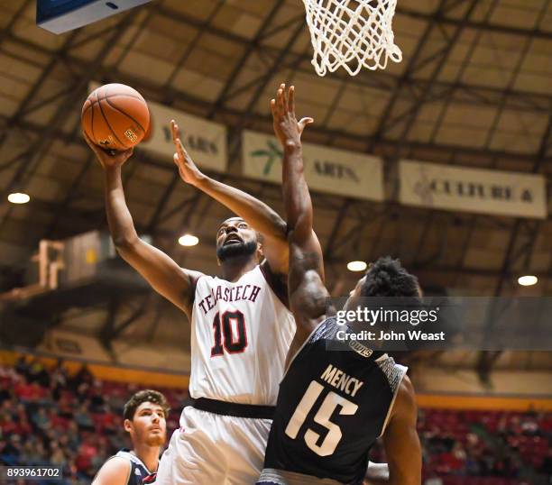 Niem Stevenson of the Texas Tech Red Raiders goes to the basket against Bishop Mency of the Rice Owls during the game on December 16, 2017 at Lubbock...