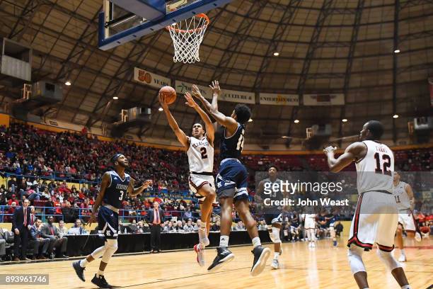 Zhaire Smith of the Texas Tech Red Raiders goes to the basket and shoots the ball against Najja Hunter of the Rice Owls during the game on December...