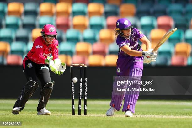 Alyssa Healy of the Sixers watches on as Lauren Winfield of the Hurricanes is bolwed by Sarah Aley of the Sixers during the Women's Big Bash League...