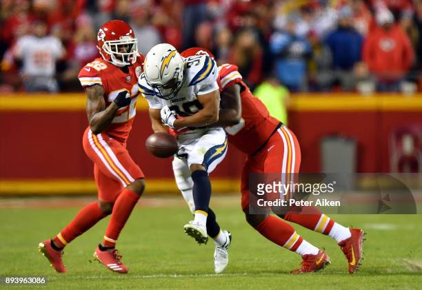 Cornerback Marcus Peters and inside linebacker Reggie Ragland of the Kansas City Chiefs strip the ball from running back Austin Ekeler of the Los...