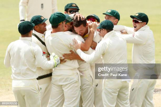 Josh Hazlewood of Australia is congratulated by team mates after taking a catch off his bowling to dismiss Alistair Cook of England during day four...