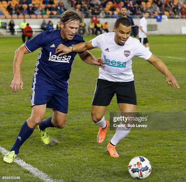 Philadelphia Union forward Charlie Davies holds off Olympic skier Bode Miller during the Kick In For Houston Charity Soccer Match at BBVA Compass...