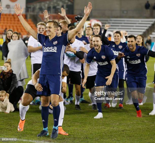 Stuart Holden celebrates after making a shot in the Skillz Challenge during the Kick In For Houston Charity Soccer Match at BBVA Compass Stadium on...