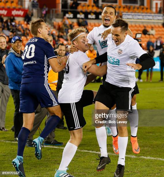Jake Paul celebrates with Stuart Holden, Charlie Davies and Steve Nash after making a shot in the Skillz Challenge during the Kick In For Houston...