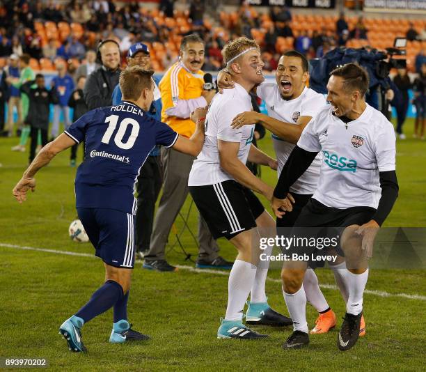 Jake Paul celebrates with Stuart Holden, Charlie Davies and Steve Nash after making a shot in the Skillz Challenge during the Kick In For Houston...