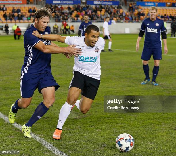 Philadelphia Union forward Charlie Davies holds off Olympic skier Bode Miller during the Kick In For Houston Charity Soccer Match at BBVA Compass...