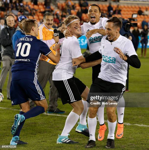 Jake Paul celebrates with Stuart Holden, Charlie Davies and Steve Nash after making a shot in the Skillz Challenge during the Kick In For Houston...