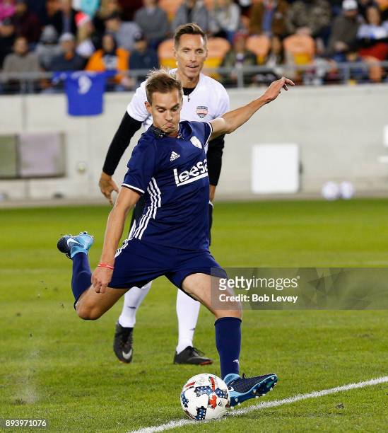 Stuart Holden scores on a penalty kick as Steve Nash looks on during the Kick In For Houston Charity Soccer Match at BBVA Compass Stadium on December...