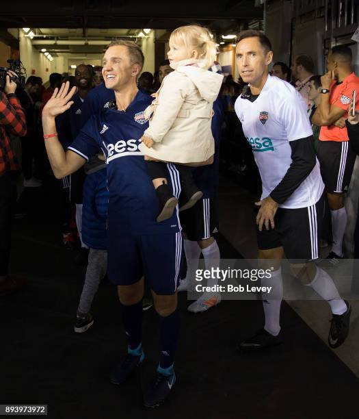 Stuart Holden, left, holding daughter Kennady and Steve Nash await to be introduced during the Kick In For Houston Charity Soccer Match at BBVA...
