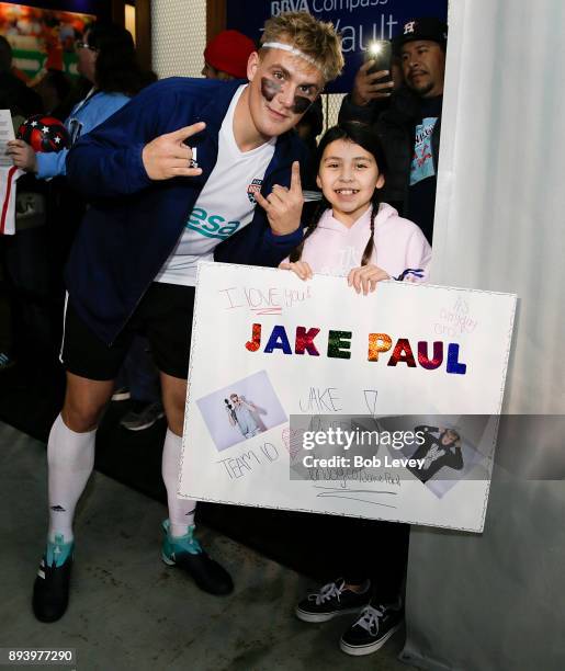 Jake Pual poses with a fan during the Kick In For Houston Charity Soccer Match at BBVA Compass Stadium on December 16, 2017 in Houston, Texas.