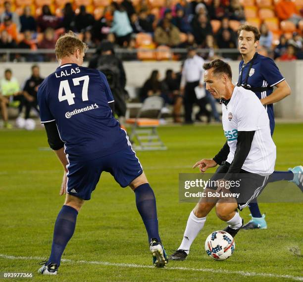 Steve Nash looks to move around Alexi Lalas during the Kick In For Houston Charity Soccer Match at BBVA Compass Stadium on December 16, 2017 in...