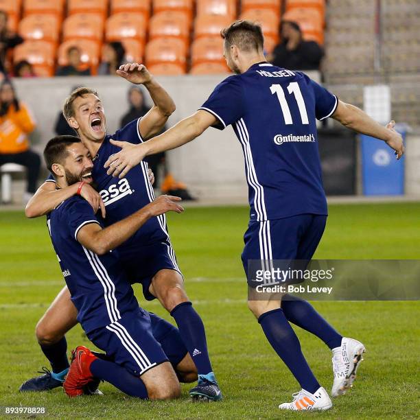 Stuart Holden celebrates with Clint Dempsey after he scored on a bicycle style kick during the Kick In For Houston Charity Soccer Match at BBVA...
