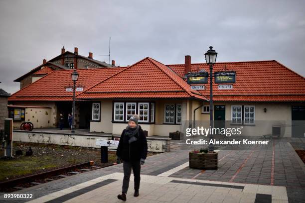 Visitor walks towards a steam powered locomotive of the Harz Narrow Gauge Railways at the station on December 16, 2017 in Wernigerode, Germany. Harz...
