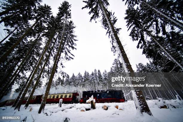 Steam powered locomotive of the Harz Narrow Gauge Railways travels through snow towards the station Brocken on December 16, 2017 in Wernigerode,...