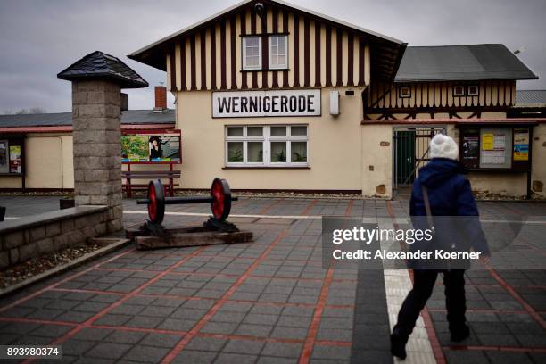 Visitor walks towards a steam powered locomotive of the Harz Narrow Gauge Railways at the station on December 16, 2017 in Wernigerode, Germany. Harz...