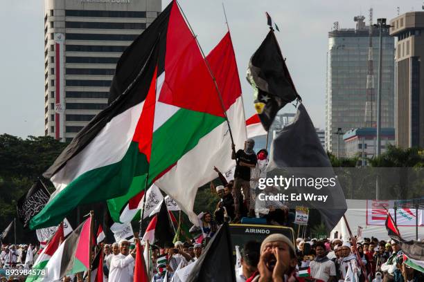 Indonesian men wave Palestinian flags at a large demonstration against the United States' decision to recognize Jerusalem as the Capital of Israel on...