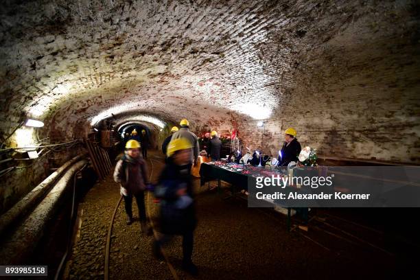 Visitors explore the Rammelsberg mine to stroll among stalls selling mulled wine and other Christmas goodies at the underground Christmas market in...