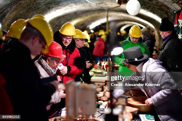 Local workers show their skills to visitors exploring the underground Christmas market in the former Rammelsberg mine on December 16, 2017 in...