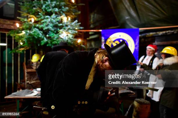 Local workers show their skills to visitors exploring the underground Christmas market in the former Rammelsberg mine on December 16, 2017 in...